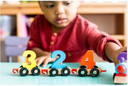 Toddler playing with counting toys