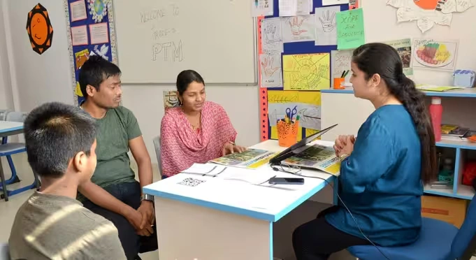 Parent meeting teacher in office